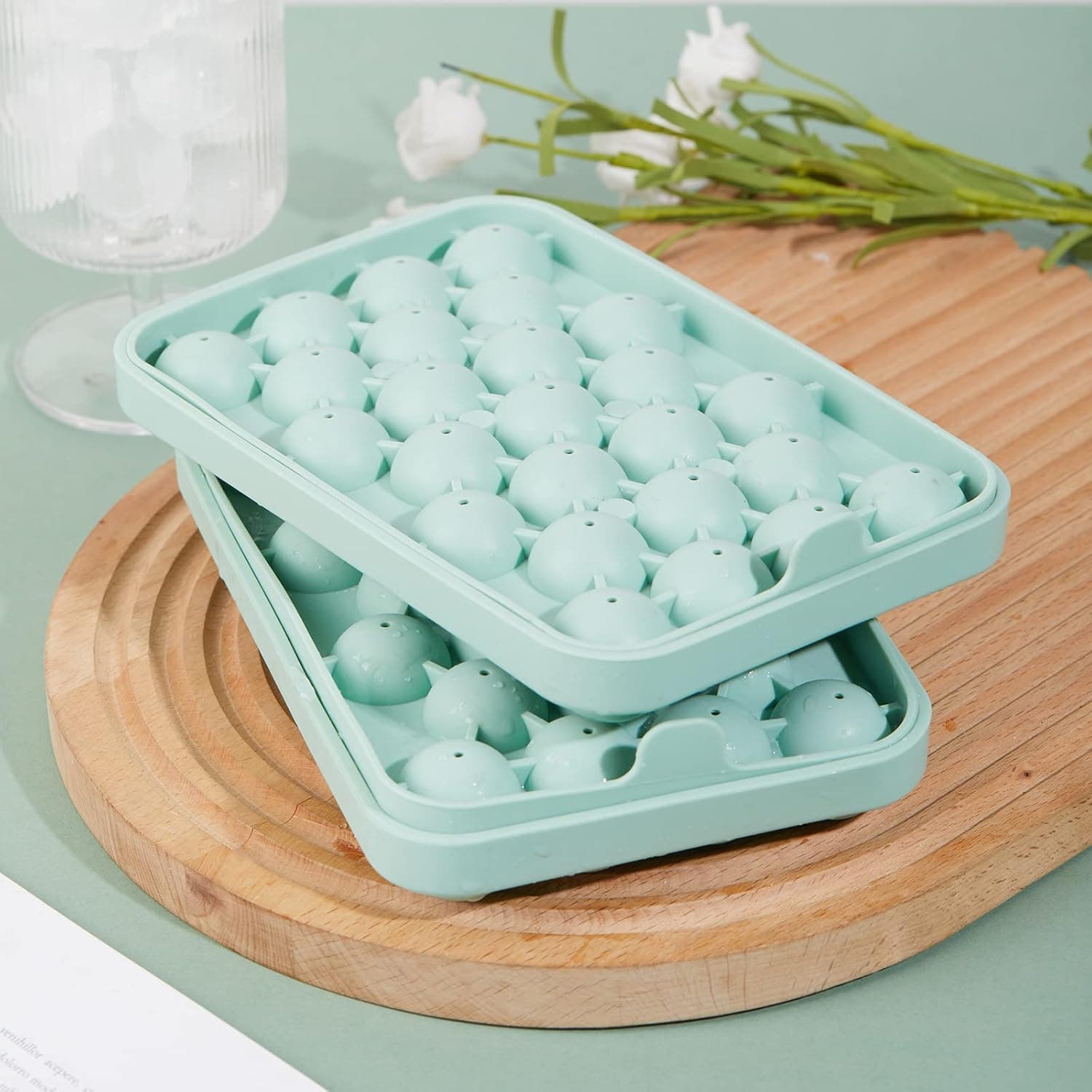 Stacked Obsoorth green silicone ice ball trays for compact freezer storage